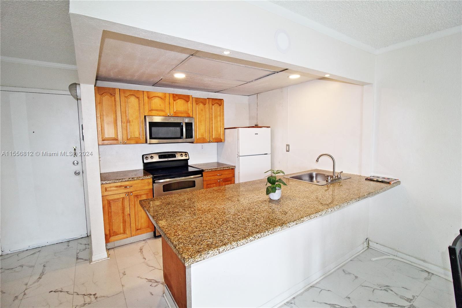 a kitchen with granite countertop counter top space cabinets and stainless steel appliances