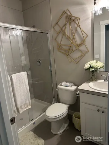 a bathroom with a granite countertop sink toilet and shower