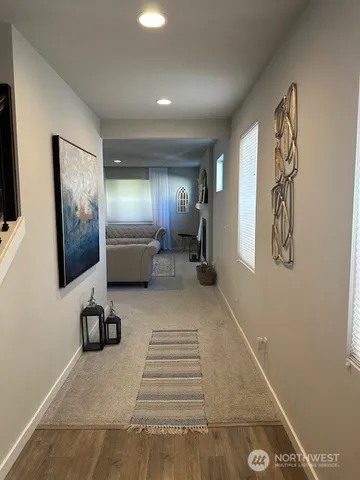 a view of a livingroom with furniture and a flat screen tv