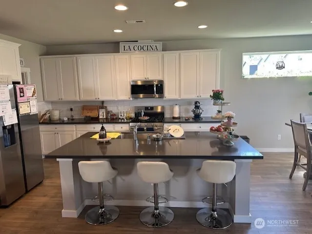 a kitchen with a sink a table and chairs
