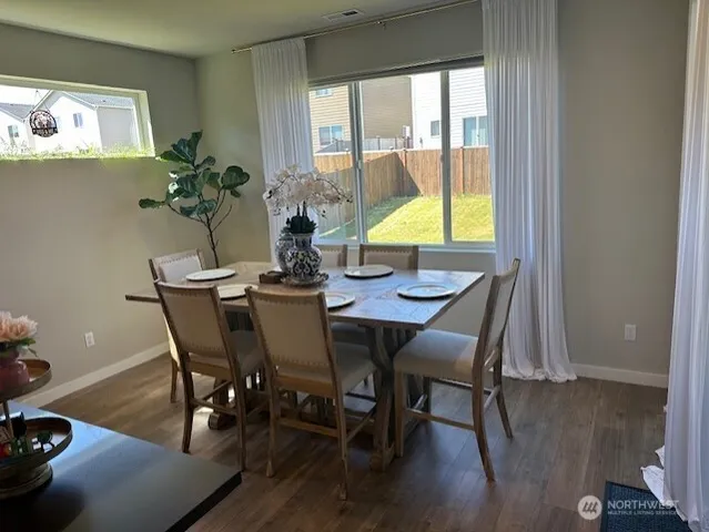 a view of a dining room with furniture and a window