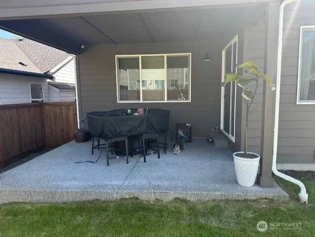 a view of a porch with chairs and a gate