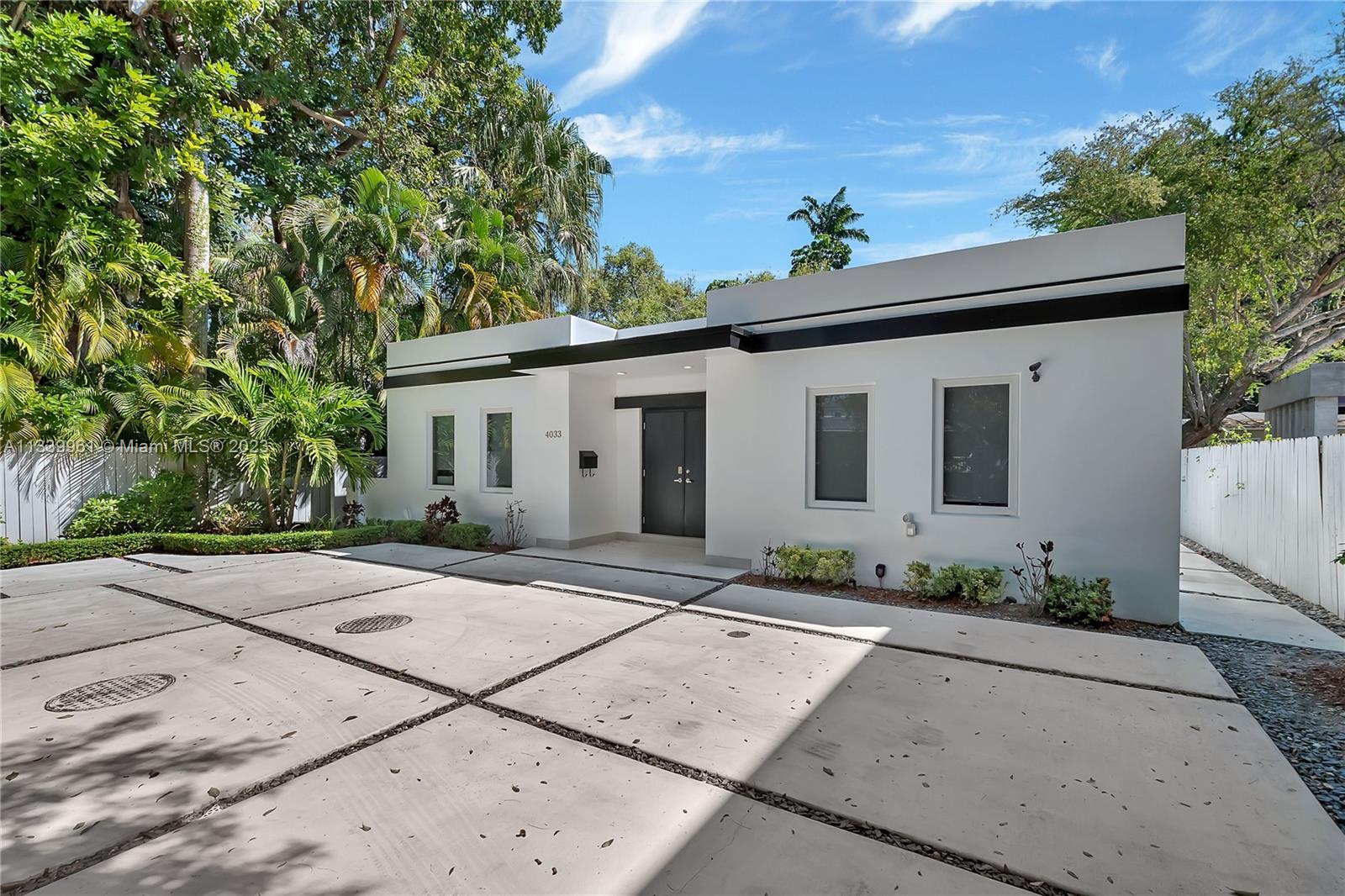 a view of a white house with a outdoor space