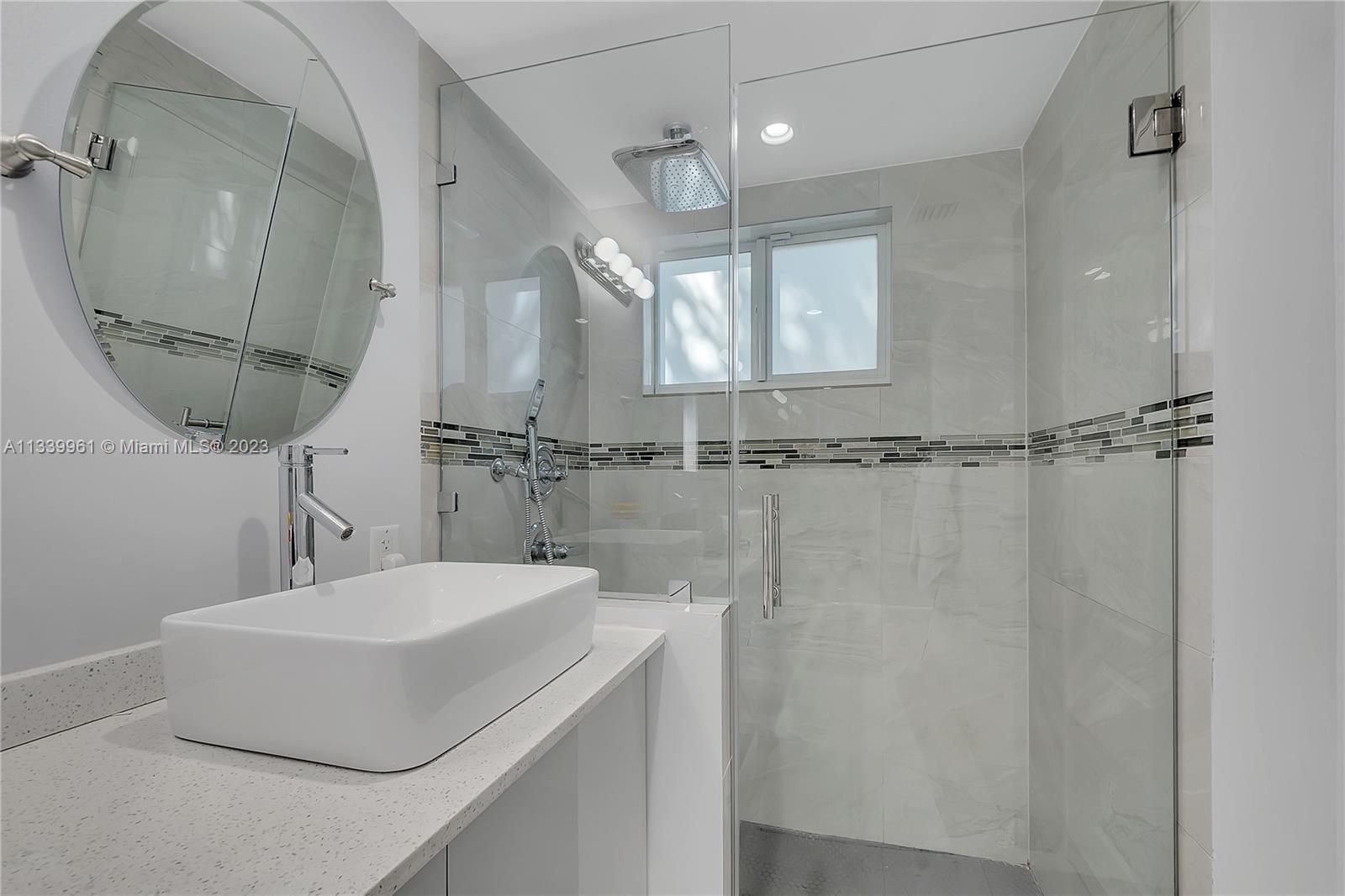4033 South Le Jeune Road Miami, FL 33146 - Photo 12 of 24 a bathroom with a sink a mirror and shower