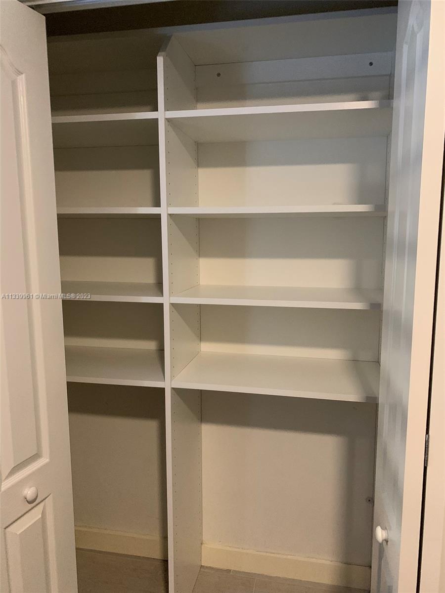 4033 South Le Jeune Road Miami, FL 33146 - Photo 18 of 24 a view of walk in closet with empty racks