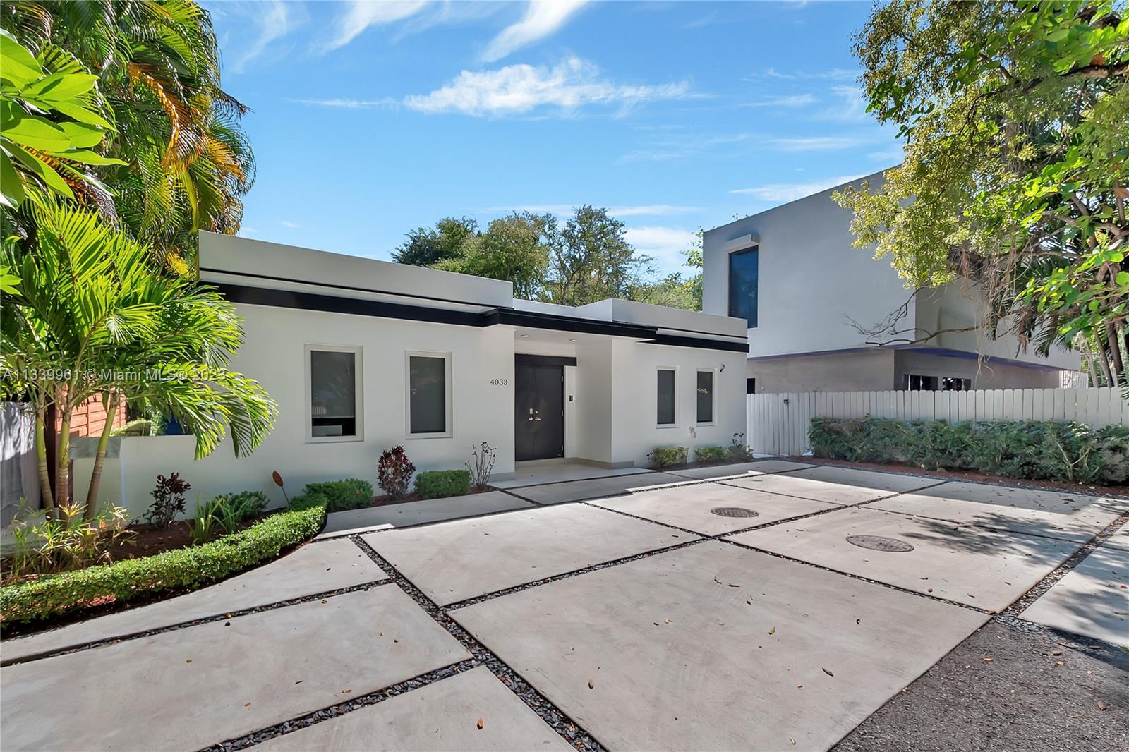 4033 South Le Jeune Road Miami, FL 33146 - Photo 3 of 24 a front view of a house with a yard and potted plants