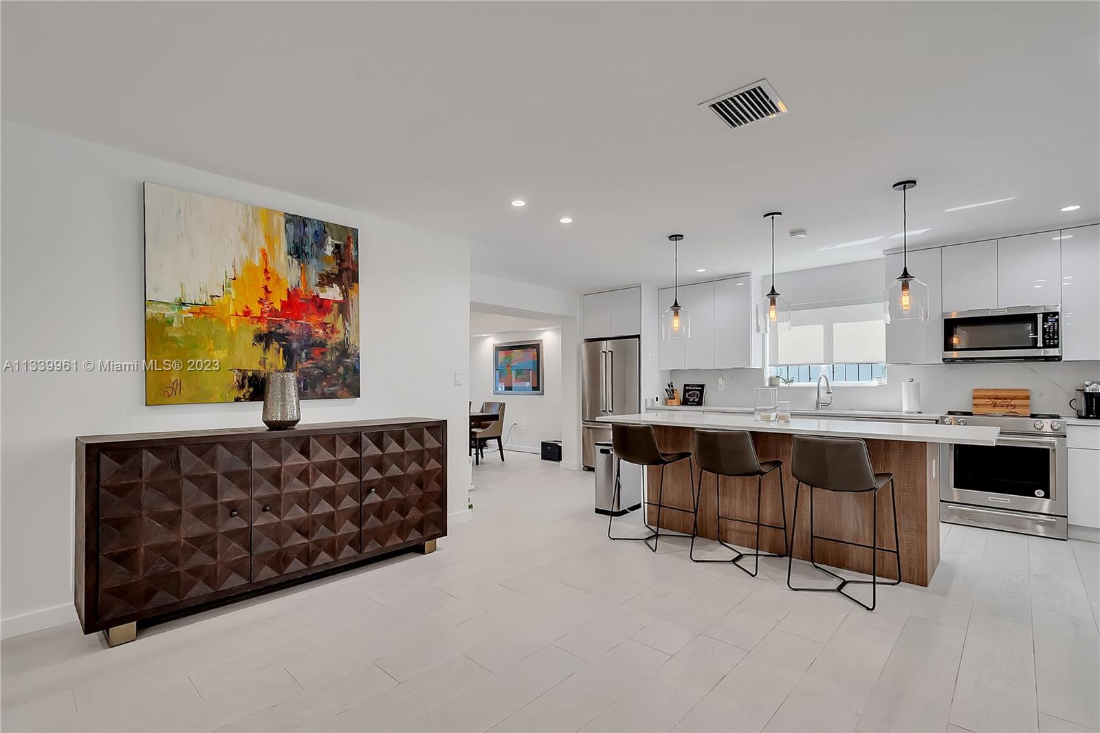 4033 South Le Jeune Road Miami, FL 33146 - Photo 4 of 24 a living room with furniture a fireplace and kitchen view