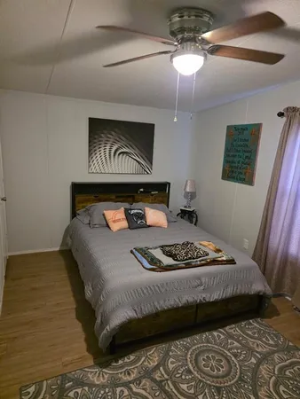 a bedroom with a bed and a lamp