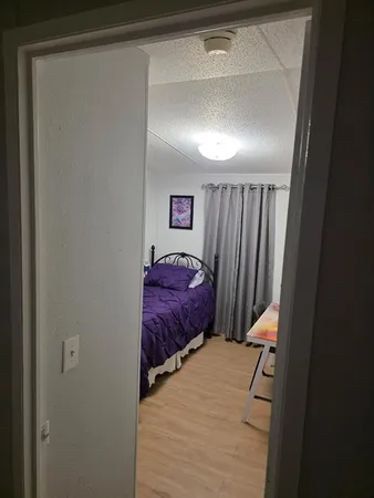 a bedroom with a bed and a mirror