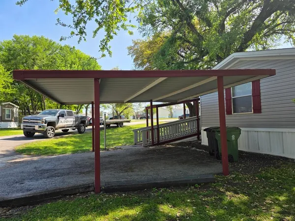 a view of a backyard with table and chairs under an umbrella