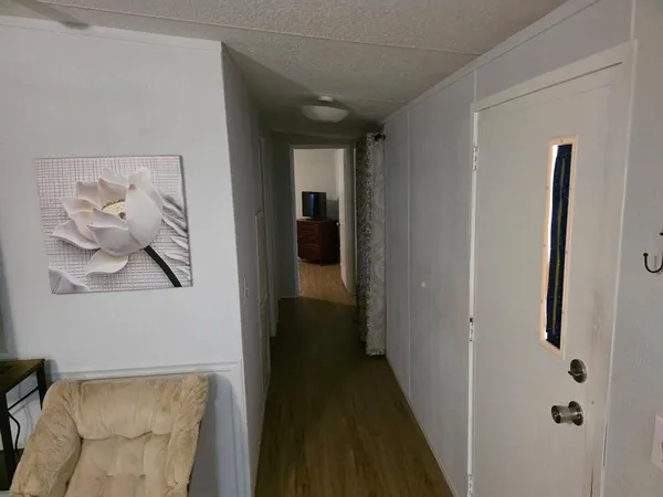 a view of a hallway with paintings on the wall
