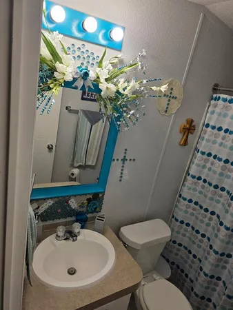 a bathroom with a toilet sink and mirror