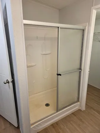 a bathroom with a glass shower door