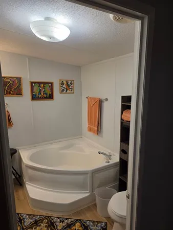 a bathroom with a toilet and a shower