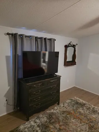 a living room with furniture and flat screen tv
