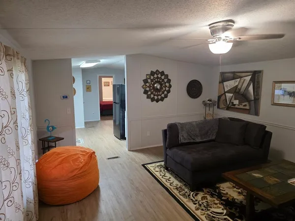a living room with furniture and a chandelier
