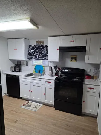 a kitchen with a sink dishwasher a stove and a refrigerator