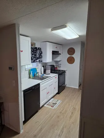 a kitchen with stainless steel appliances granite countertop a sink and a stove top oven