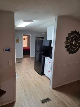 a view of a utility room with closet and wooden floor