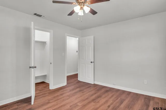 an empty room with wooden floor and door