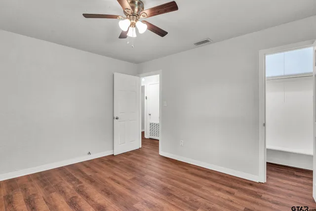 a view of an empty room with wooden floor