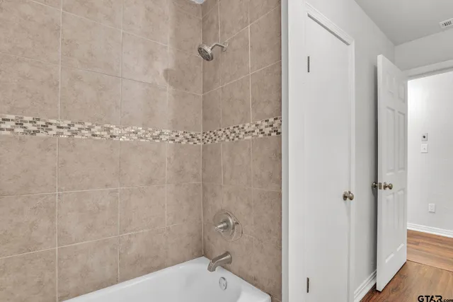 a bathroom with a granite countertop shower