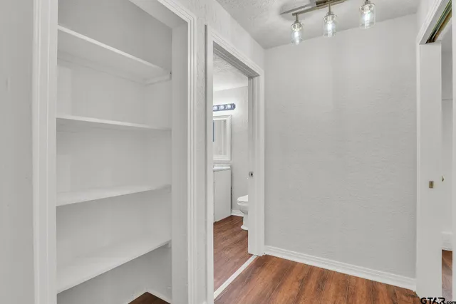 a view of a hallway with wooden floor
