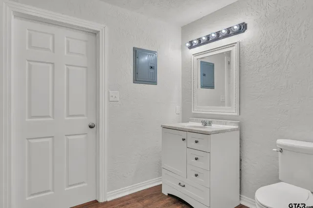 a bathroom with a toilet sink and mirror