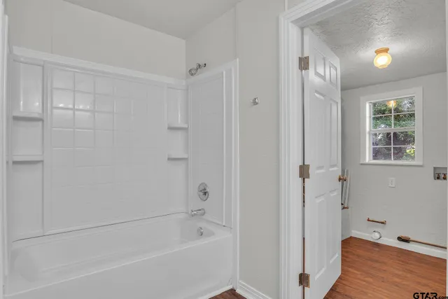 a bathroom with a bathtub and a shower