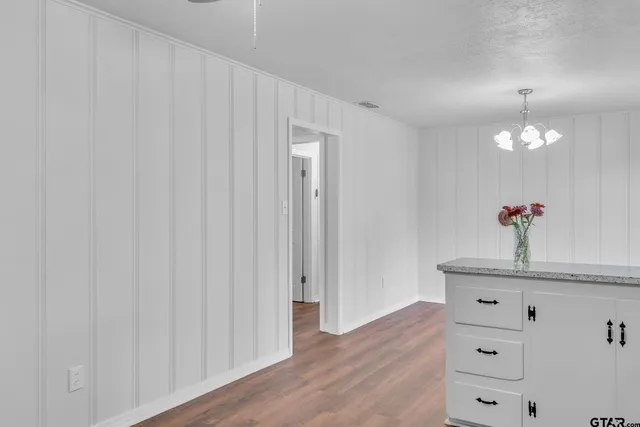 a view of a hallway with chandelier