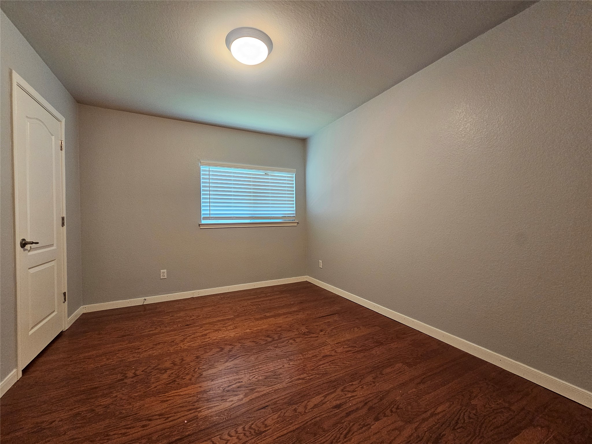 2035 Intrepid Drive Buda, TX 78610 - Photo 17 of 26 Rich hardwood flooring complements soft-toned walls in this inviting room, ready for personalization.