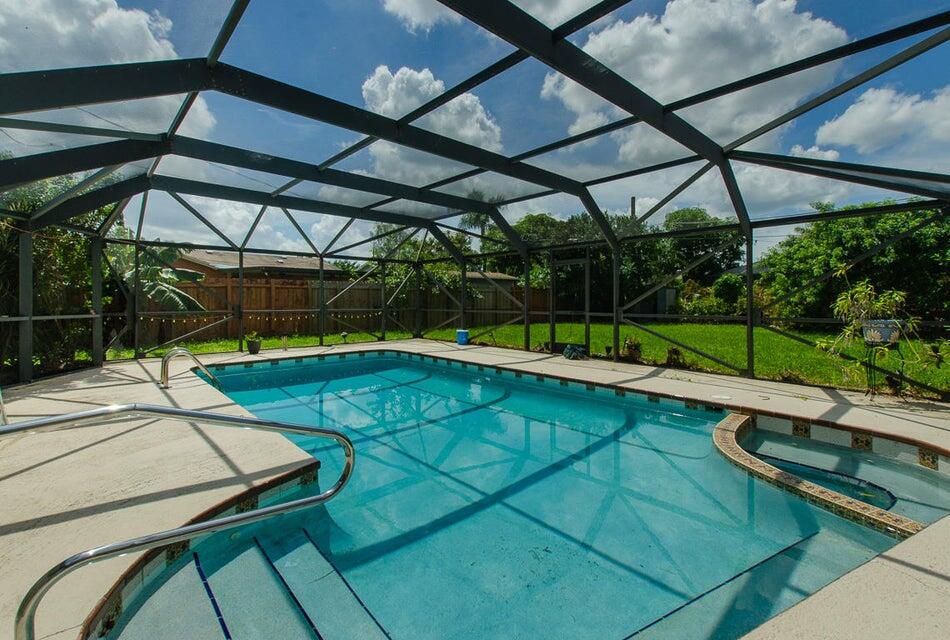 a view of a backyard with a small deck and a chair