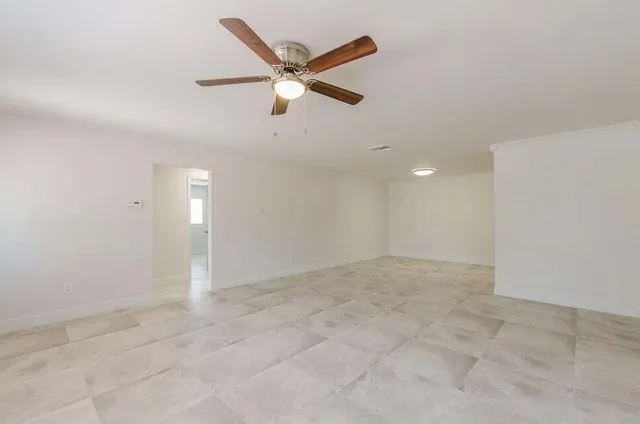 a view of an empty room with a window