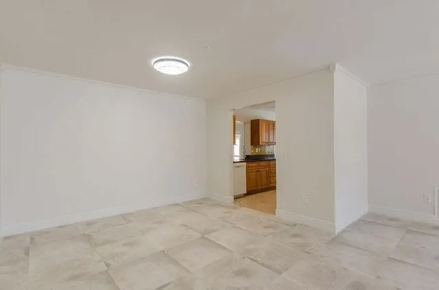 a kitchen with granite countertop cabinets stainless steel appliances a sink and a window