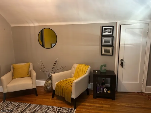 a living room with furniture and a mirror
