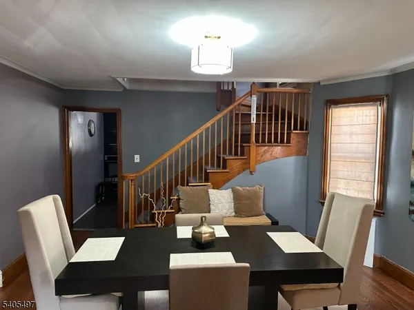 a dining room with furniture a rug and wooden floor