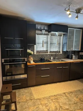 a kitchen with wooden cabinets and a sink