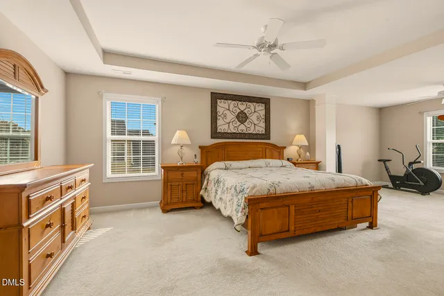 a bedroom that has a bed and a table in it