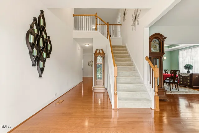 a view of entryway with wooden floor and stairs