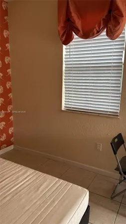 a bathroom with a sink and a chair