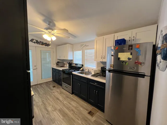 a bedroom with a bed and a mirror on the dresser