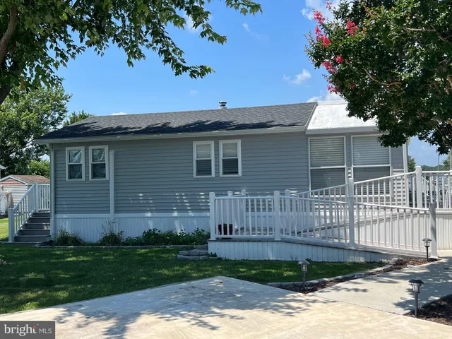 a view of a house with wooden fence