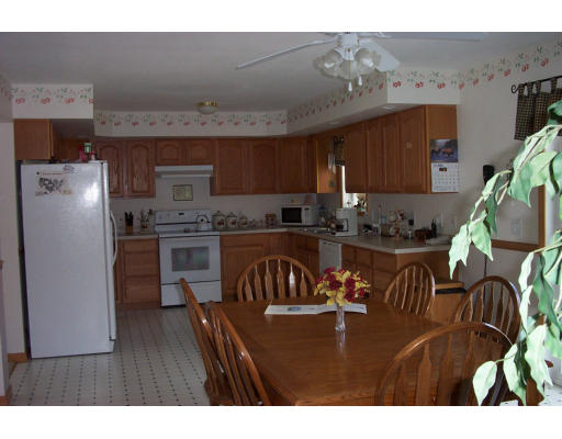 511 Woods Road Barre, MA 01068 - Photo 2 of 6 a kitchen with stainless steel appliances granite countertop a refrigerator a stove and a sink with wooden floor