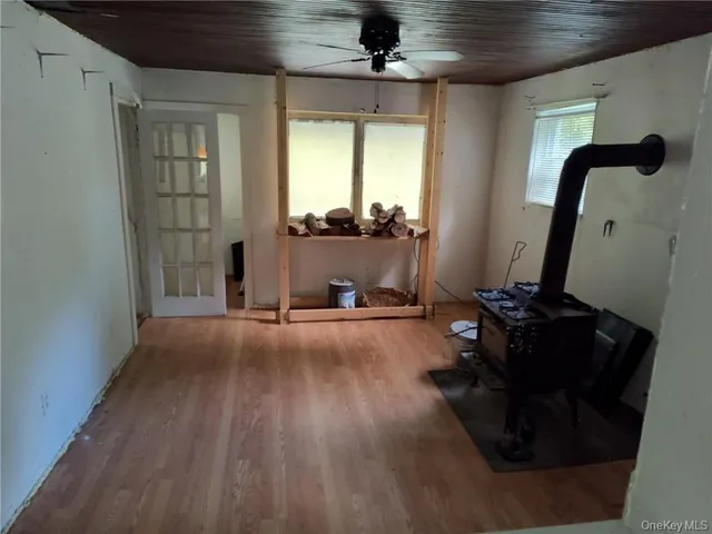a room with hard wood floor and a mirror