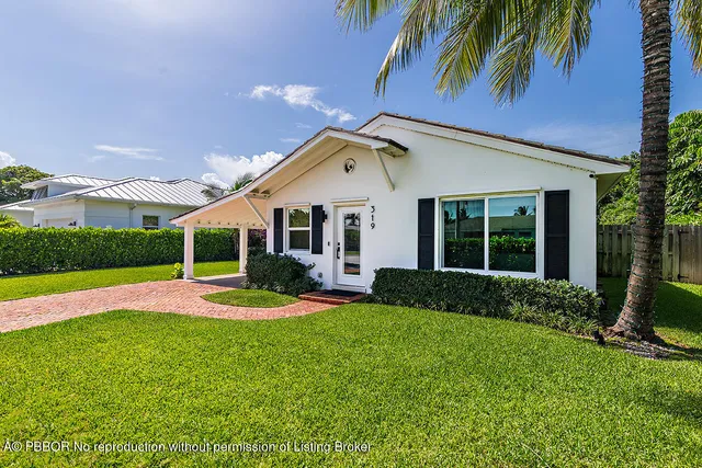 a view of a house with a yard and sitting area