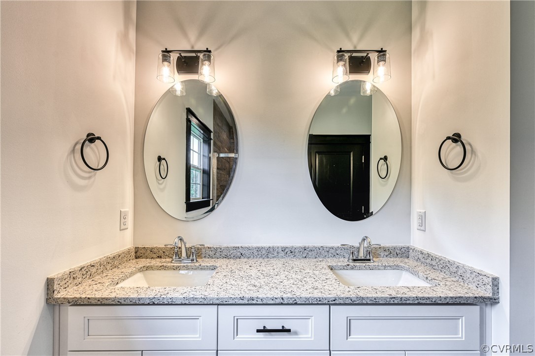 694 Gardners Road Mineral, VA 23117 - Photo 21 of 41 a bathroom with double vanity sinks and a mirror