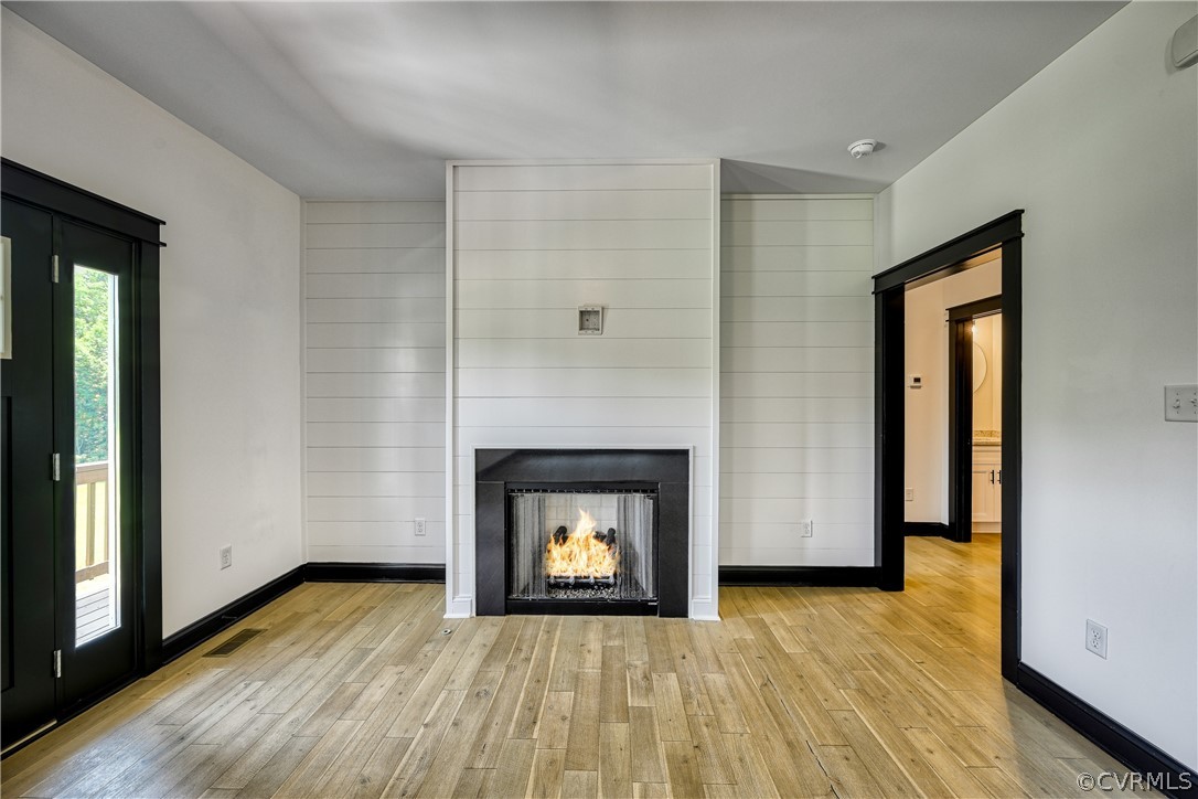 694 Gardners Road Mineral, VA 23117 - Photo 7 of 41 a view of an empty room with wooden floor and a fireplace