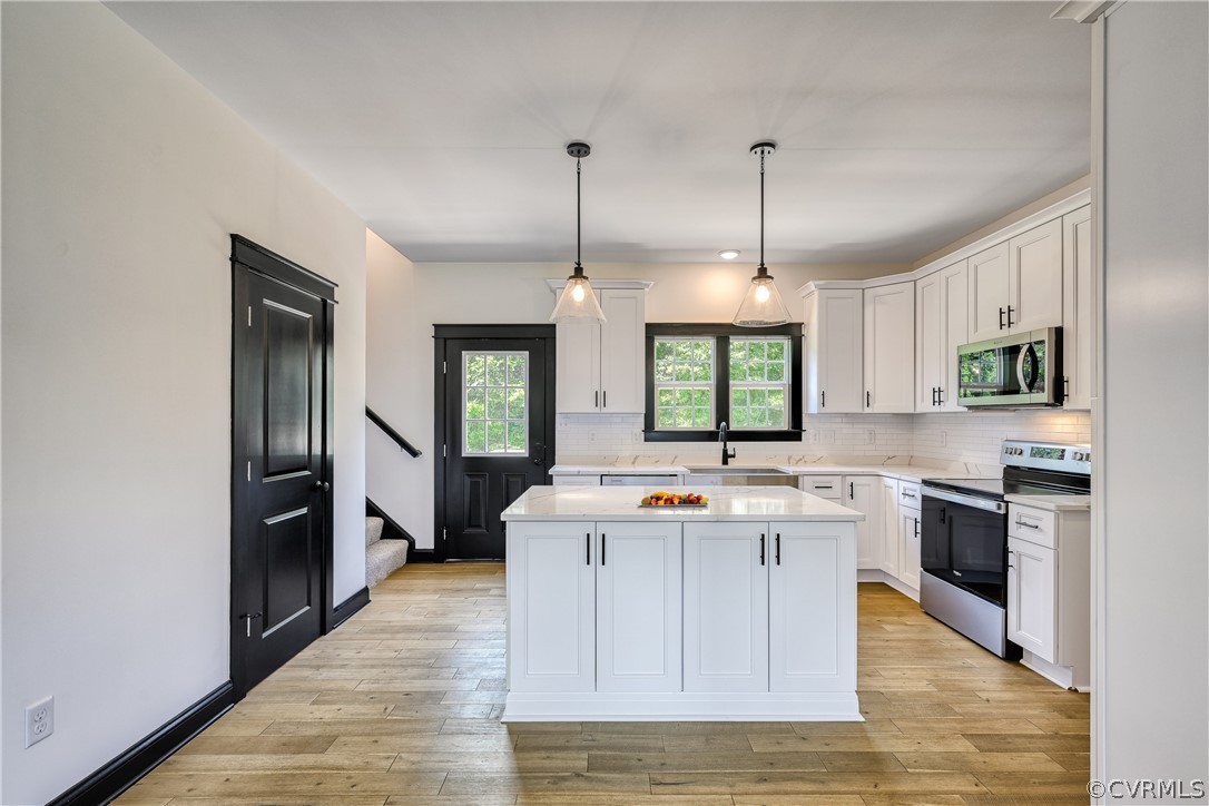 694 Gardners Road Mineral, VA 23117 - Photo 9 of 41 a kitchen with kitchen island granite countertop a stove and a wooden floors