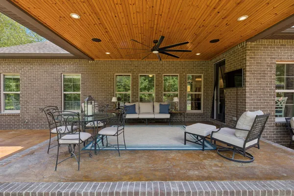 a view of a balcony with wooden floor and potted plants