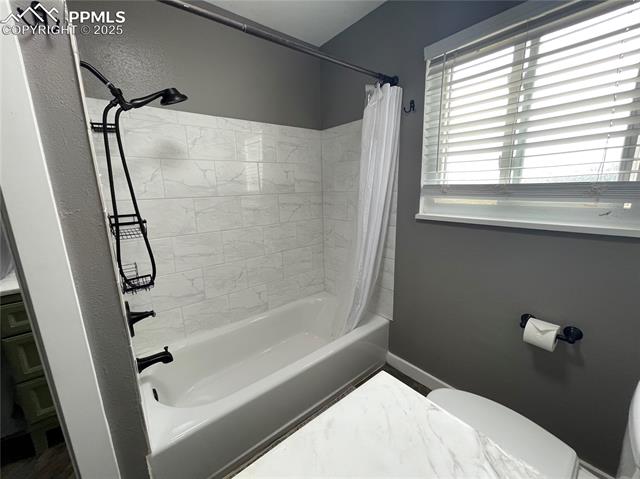 1914 Wooten Road Colorado Springs, CO 80915 - Photo 22 of 39 Bathroom featuring shower / bath combo and toilet
